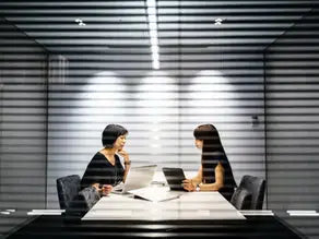 Black leather laptop bag with silver hardware in coaching journey