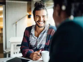 White ceramic mug with black handle and rim in consulting article